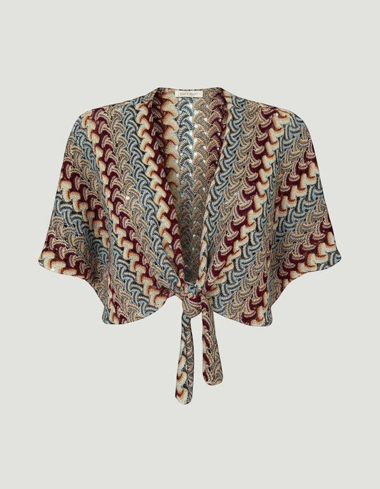 Bolero hippie de A F R A A T E L I E R en tejido de punto multicolor con patrón geométrico y cierre de nudo frontal