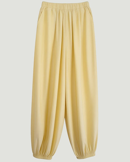 Pantalones amarillos estilo bombacho de A F R A A T E L I E R con cintura elástica y bajos ajustados.